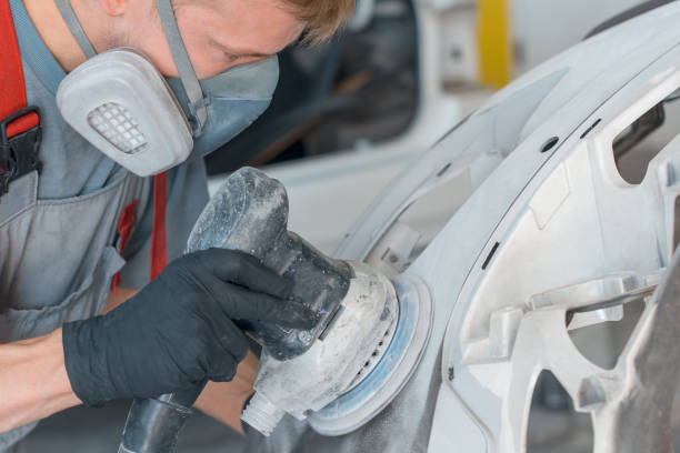 Auto mechanic restores car body part after car accident